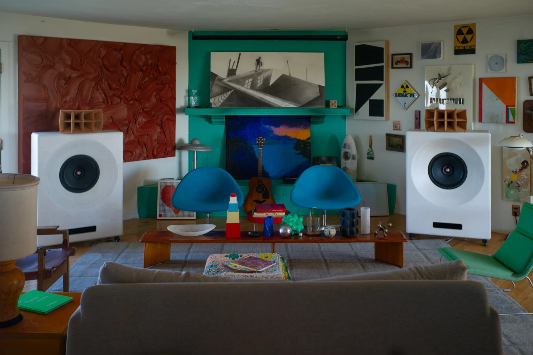 White Cobalt speakers among artwork and colorful furniture in a listening room